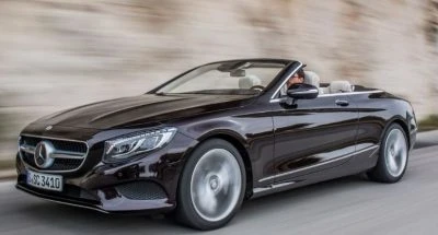 Side view of Mercedes Benz 2017 S Class Cabriolet , going fast the way it's supposed to.