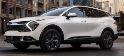 2024 Kia Sportage Hybrid SUV side view in white.